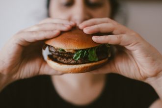 Vegan burger held by two hands