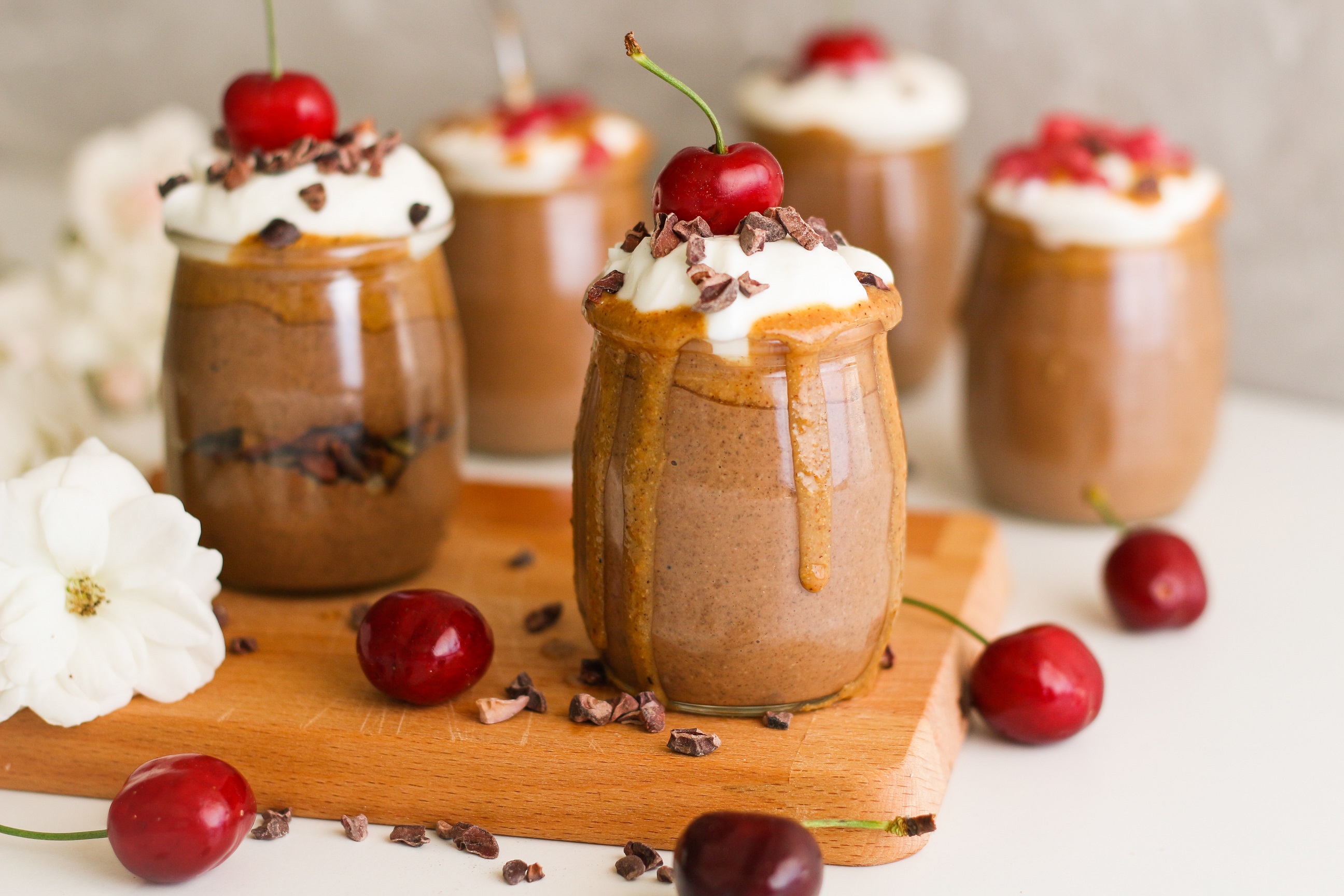 Milk-based chocolate drink with whipped cream and cherry on top