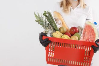 woman holding basket of groceries