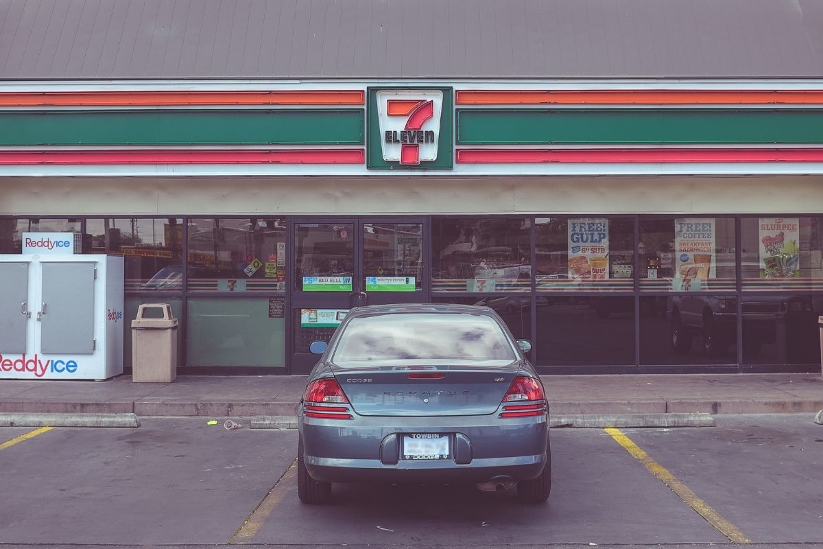 7-Eleven convenience store with a car parked out the front